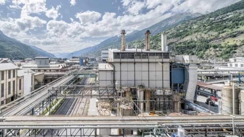an industrial plant surrounded by hills